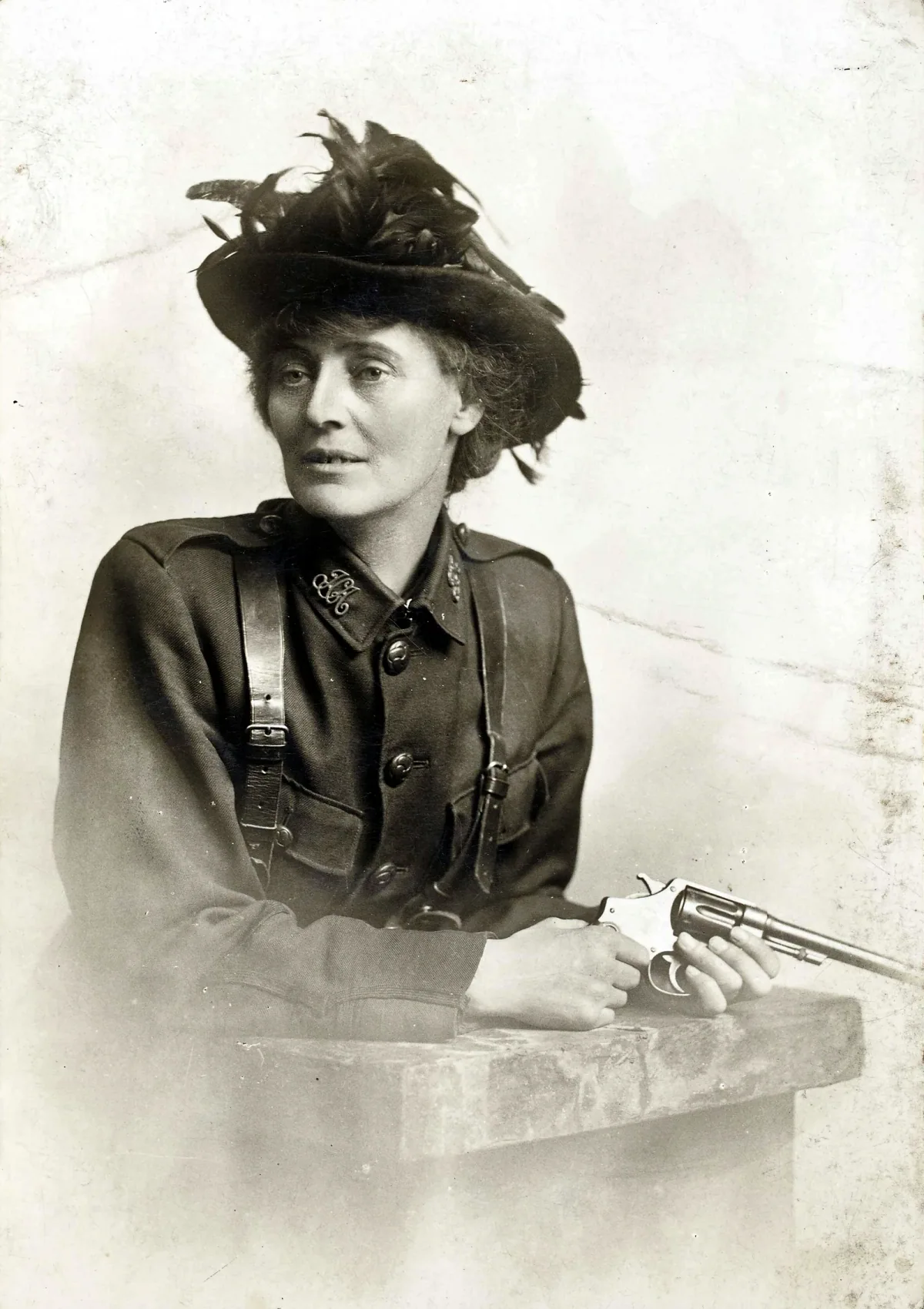 Historical portrait of Constance Markievicz seated at a table wearing a hat